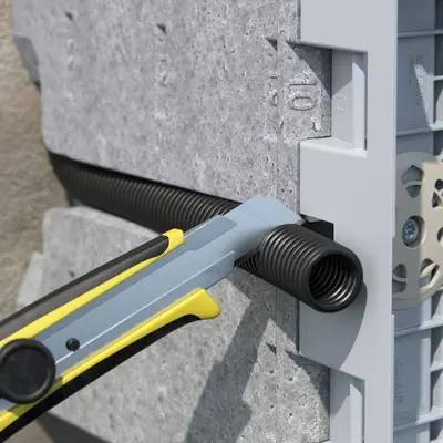 Press the conduit into the sideway guide and cut it to length.