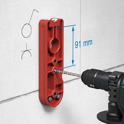 Drill the first centring hole through the guide hole in the drilling template at a distance of 91 mm.