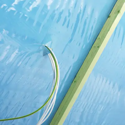 The cables are fed through the building's air-tight seal. This entry must be permanently sealed air-tight.