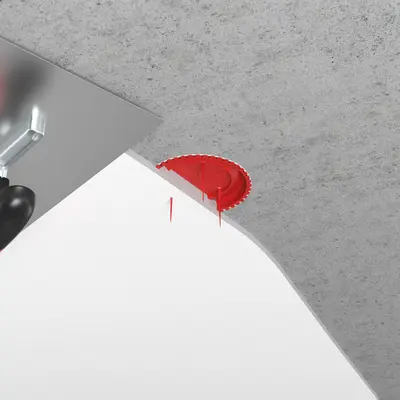 Les picots de repérage rouges sont flexibles pendant le processus de lissage et n'entravent pas cette étape, tout en étant suffisamment stables pour garder leur position dans la surface de l'enduit.